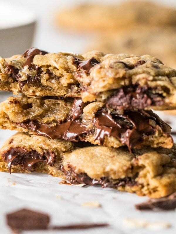 Several halves of choc-oat-chip cookies stacked on top of each other.