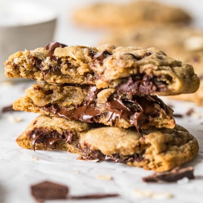 Several halves of choc-oat-chip cookies stacked on top of each other.
