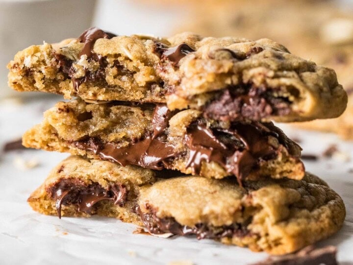 Several halves of choc-oat-chip cookies stacked on top of each other.
