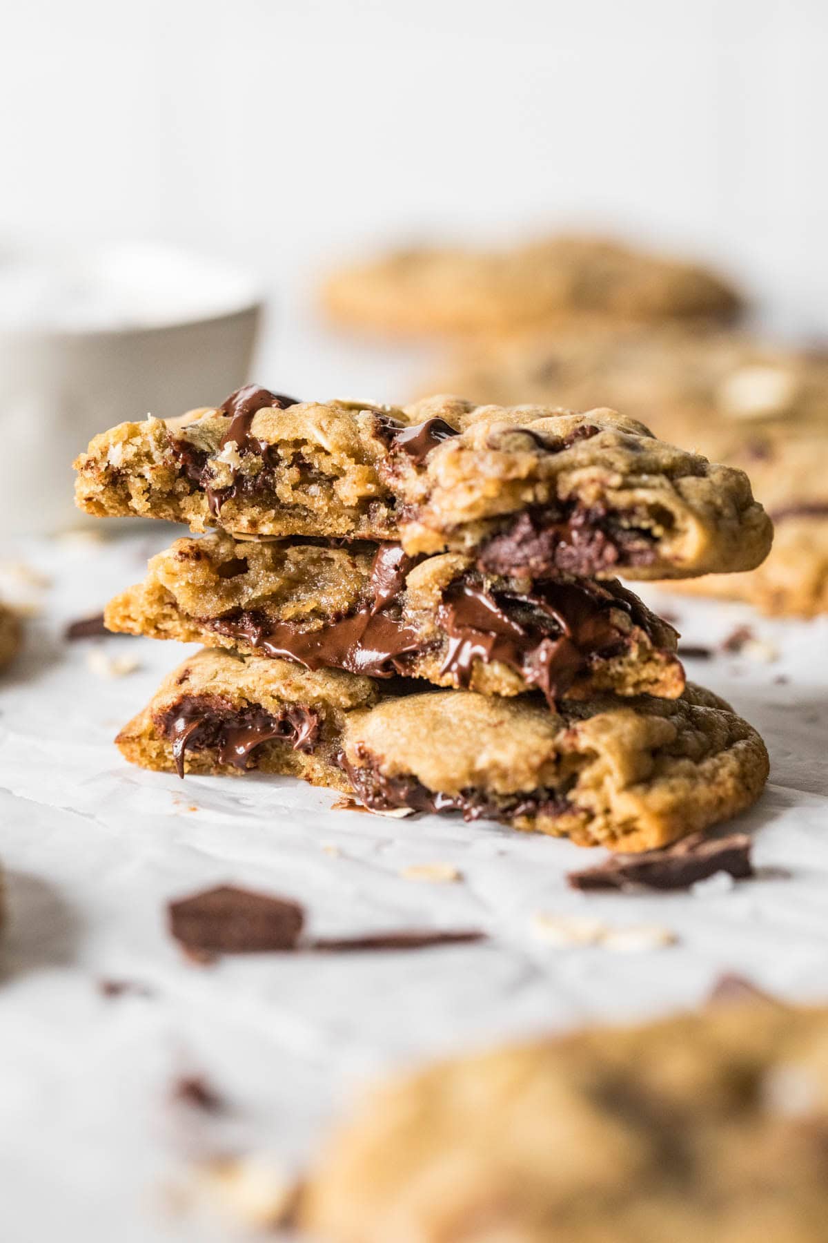 Several halves of choc-oat-chip cookies stacked on top of each other.