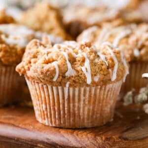 Close-up view of coffee cake muffins drizzled with a vanilla glaze.