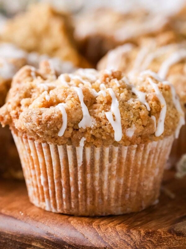 Close-up view of coffee cake muffins drizzled with a vanilla glaze.