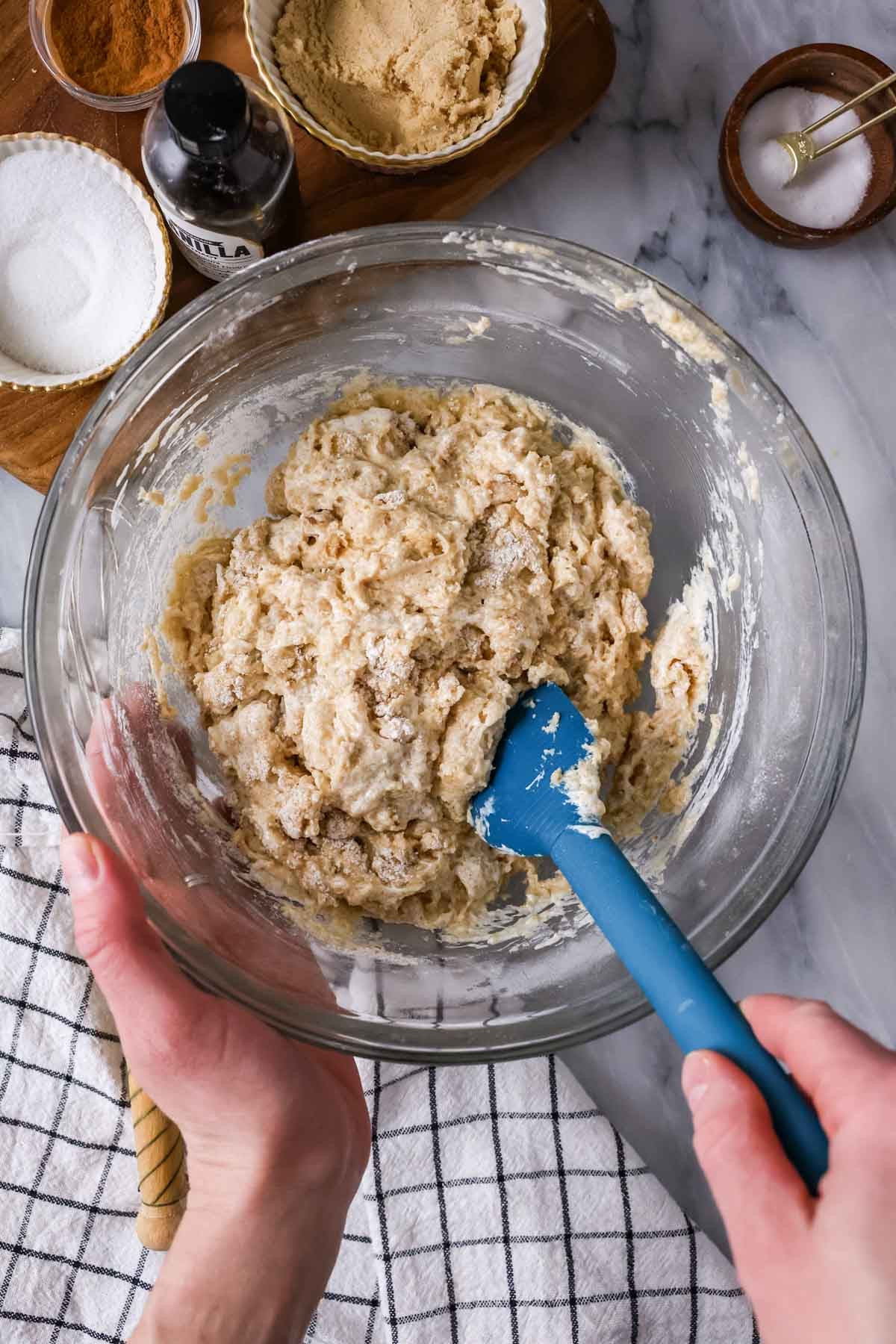 Spatula stirring muffin batter together.