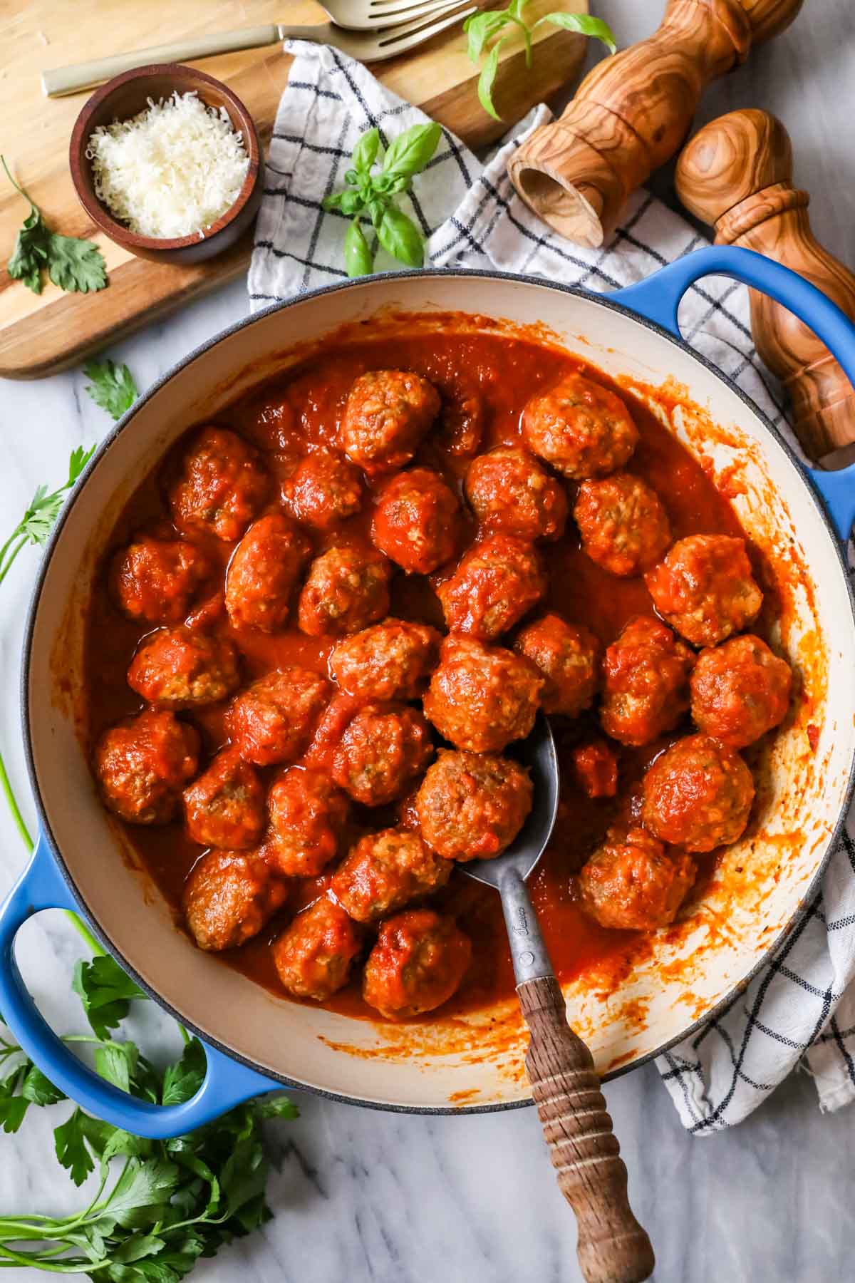 Overhead view of meatballs and tomato sauce in a skillet.