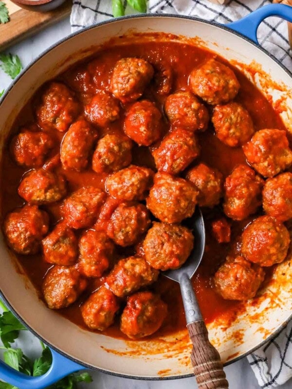 Overhead view of meatballs and tomato sauce in a skillet.