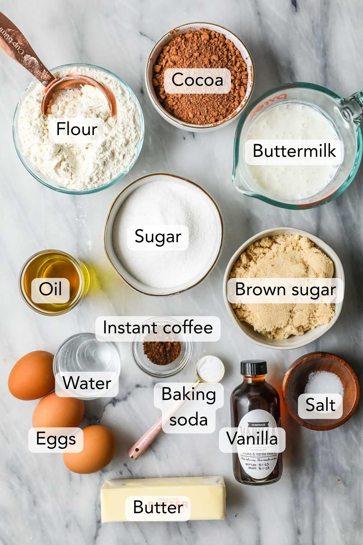 Overhead view of ingredients for my German chocolate cake recipe including flour, cocoa powder, brown sugar, and more.