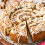 Close-up view of a cinnamon roll cheesecake that's been cut into slices.