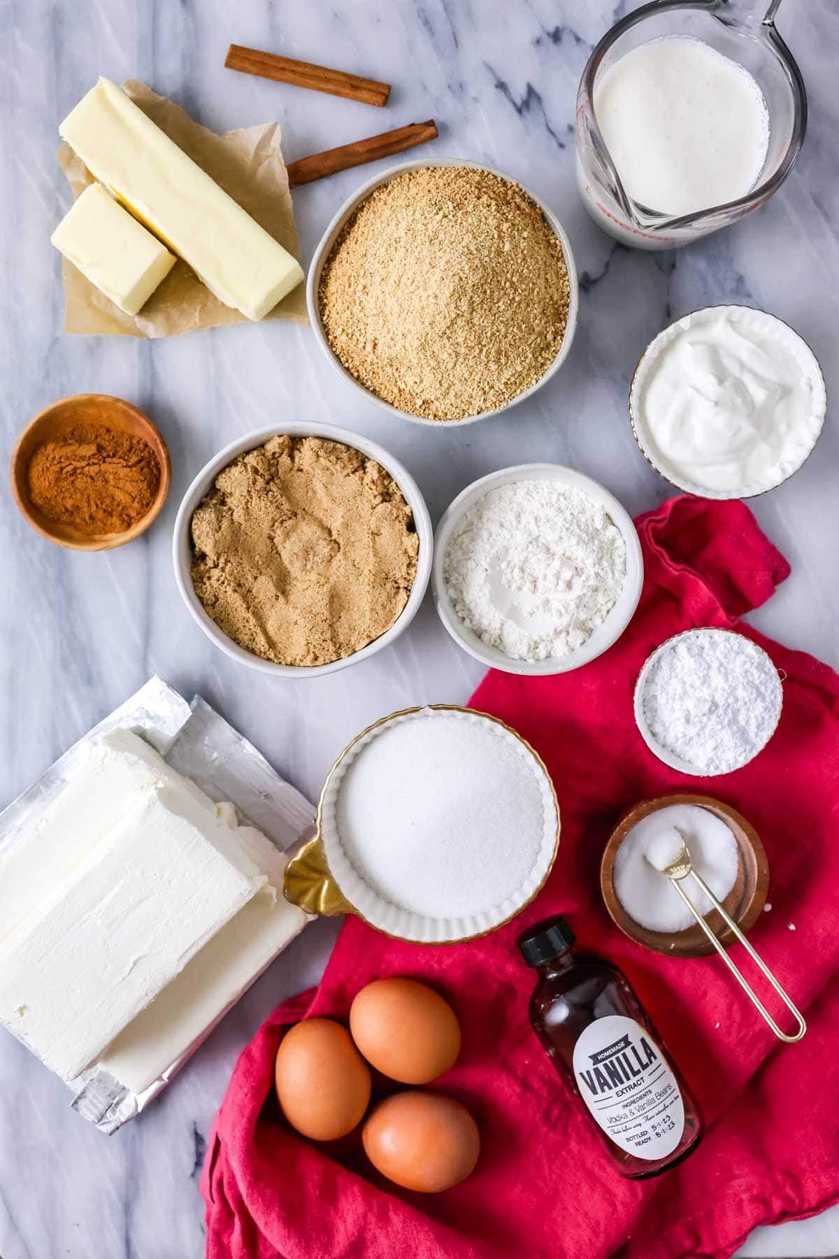 Overhead view of ingredients including cinnamon, cream cheese, brown sugar, and more.