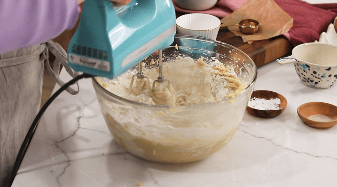 Dry ingredients being mixed into a creamed butter and sugar mixture.