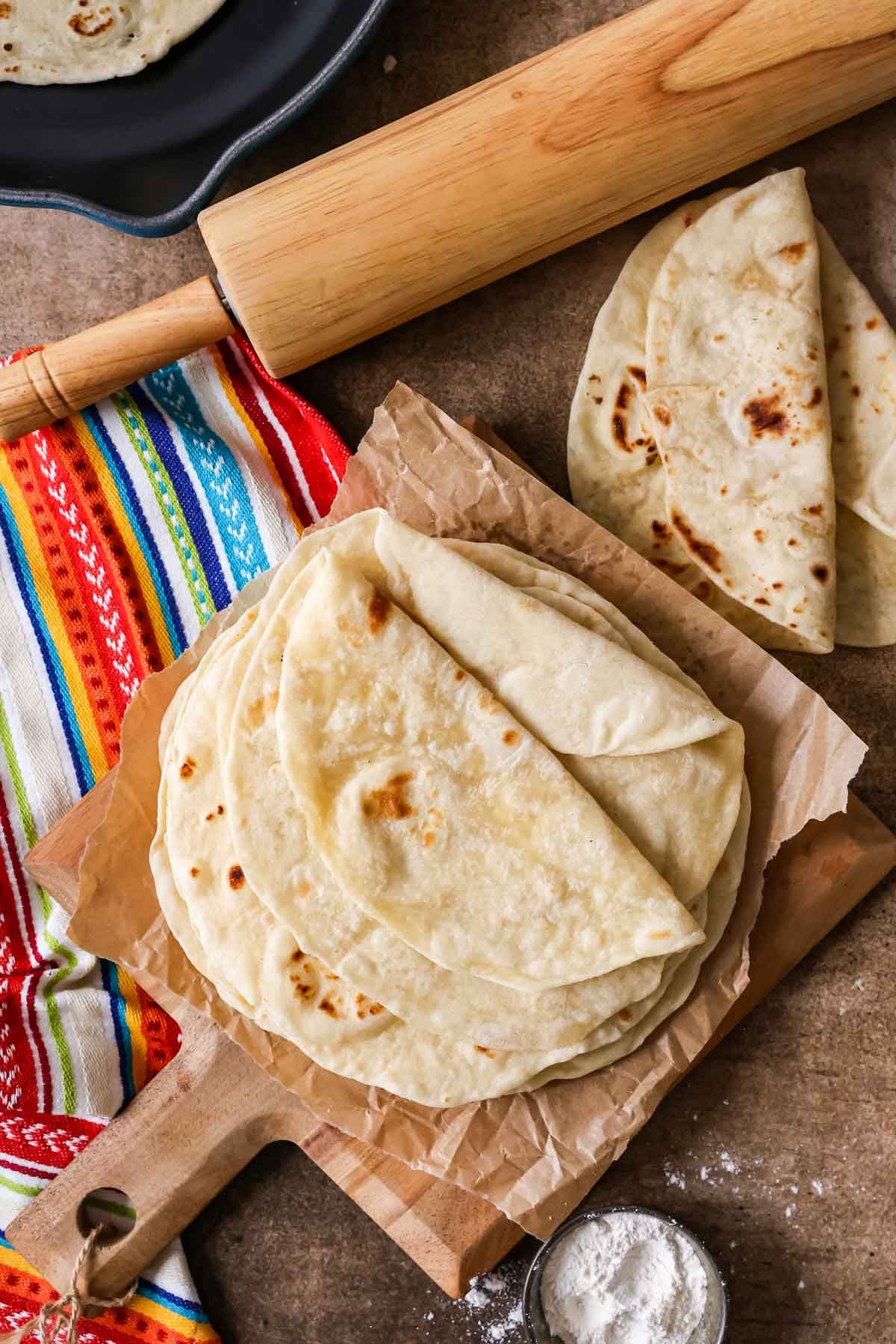 Overhead view of a pile of homemade tortillas.