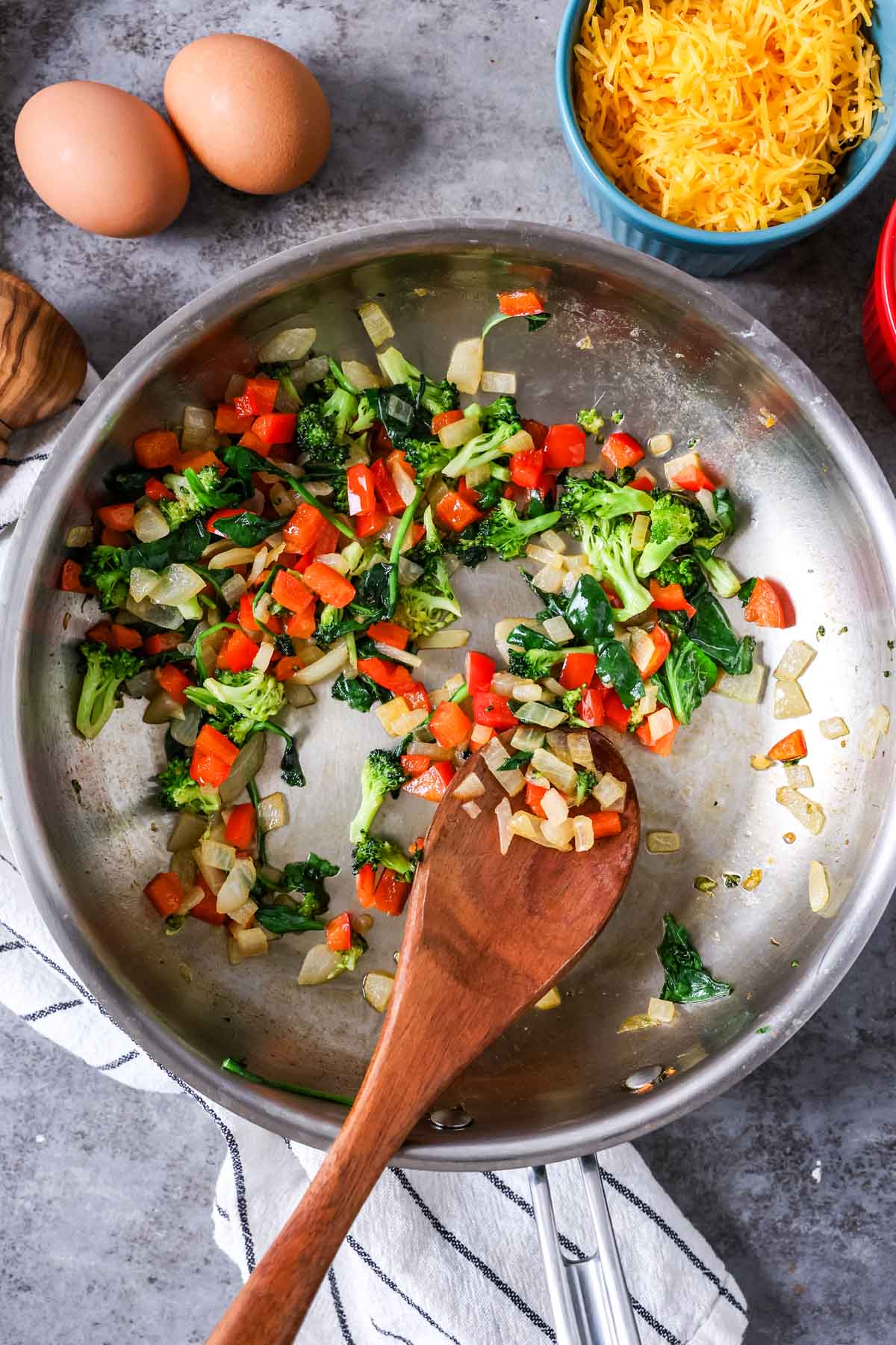 Overhead view of small diced veggies cooking in a pan.