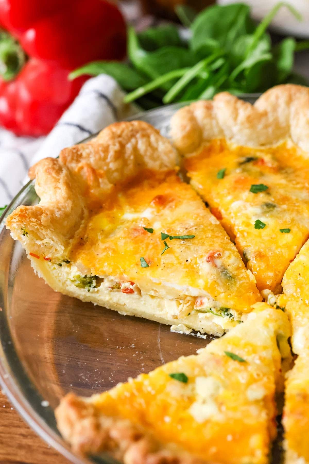 Slices of quiche in a pie plate.