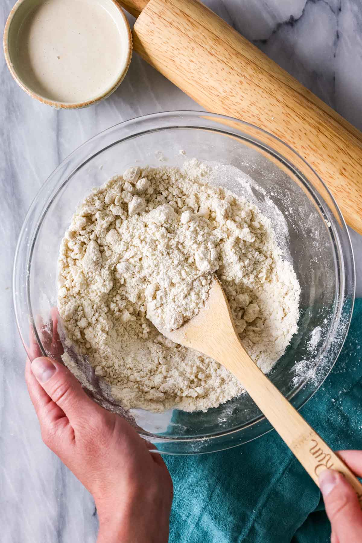 Overhead view of a dry, sandy mixture after cutting butter into dry ingredients.