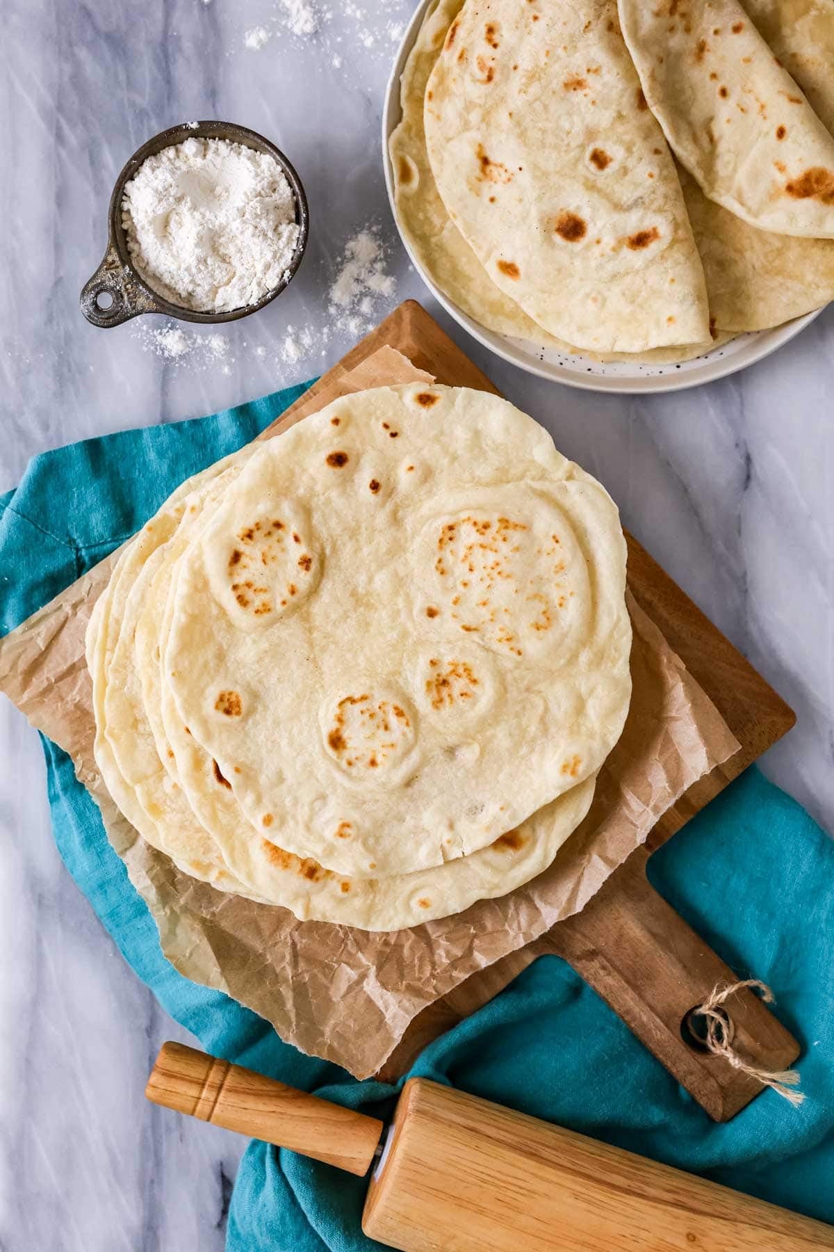 Overhead view of a pile of flour tortillas made with sourdough discard.