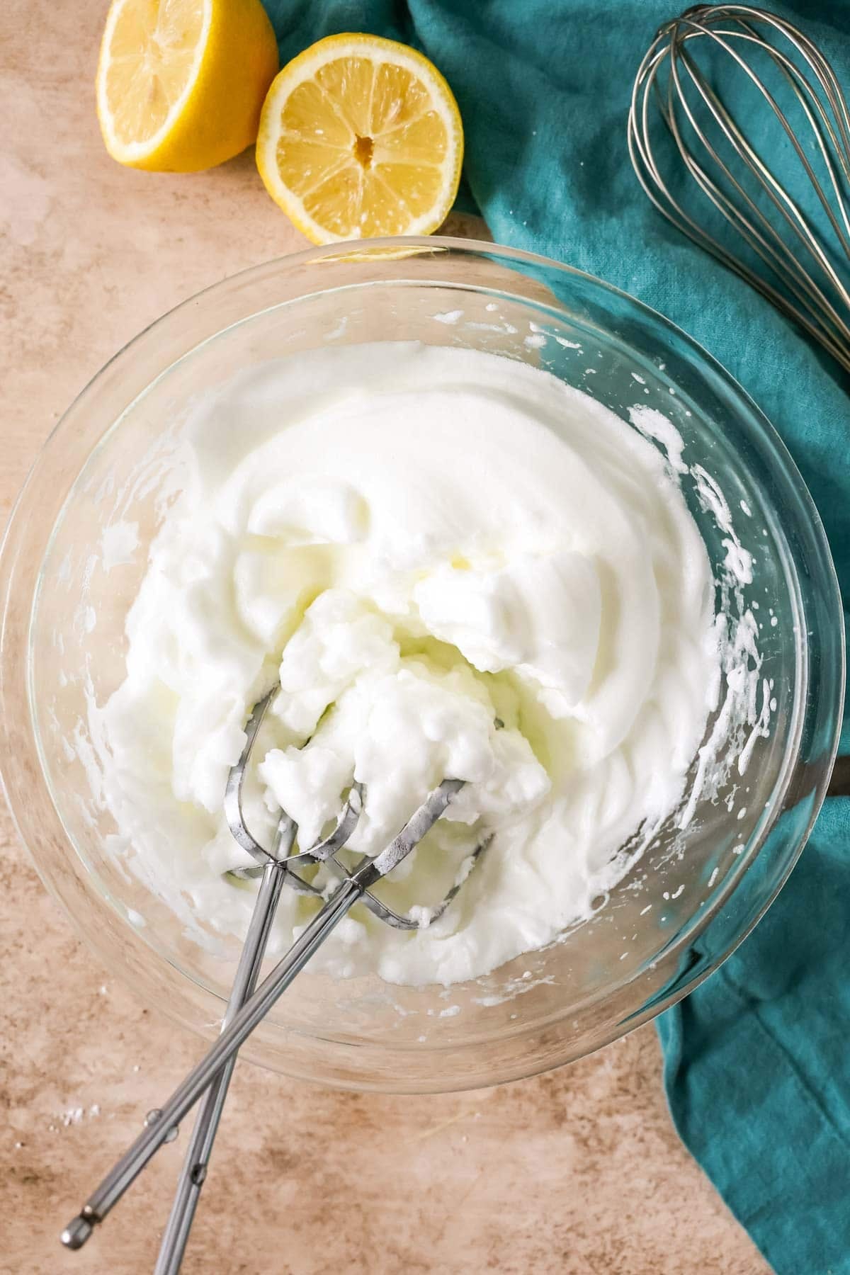 Overhead view of a bowl of egg whites that have been whipped to stiff peaks.