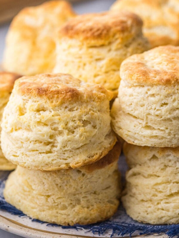 Plate of buttermilk biscuits with tall, flaky layers.