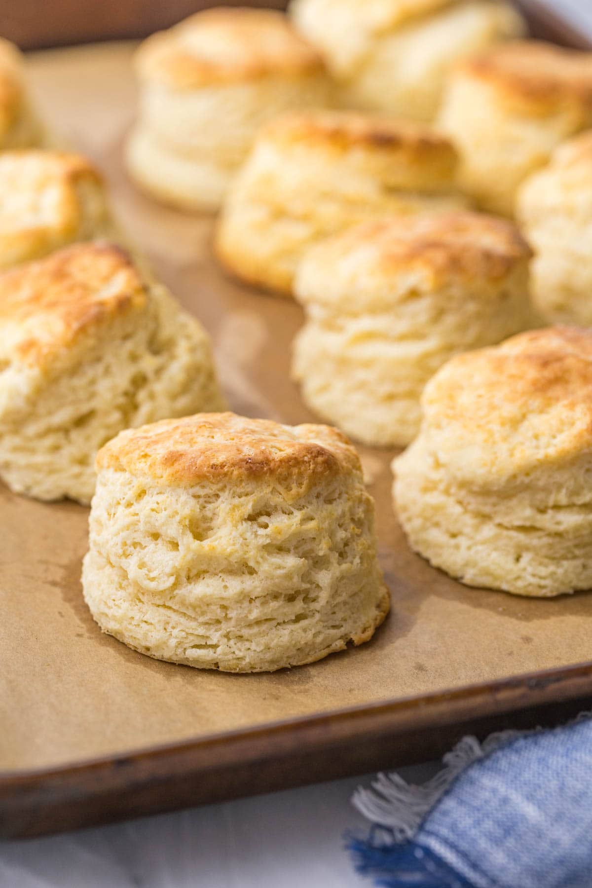 Close-up view of tall, flaky biscuits made with buttermilk.