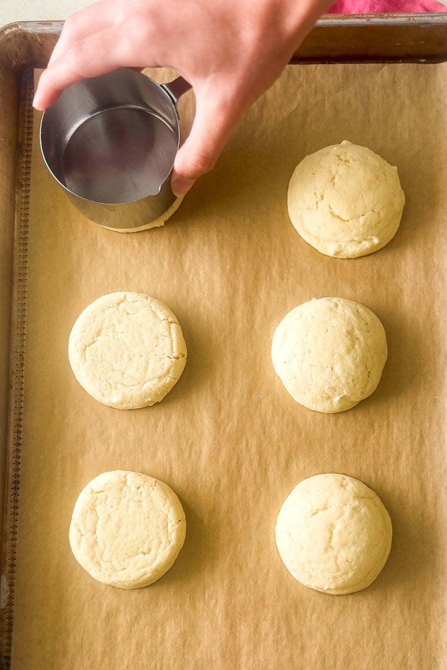 Overhead view of flattening cookies after baking.