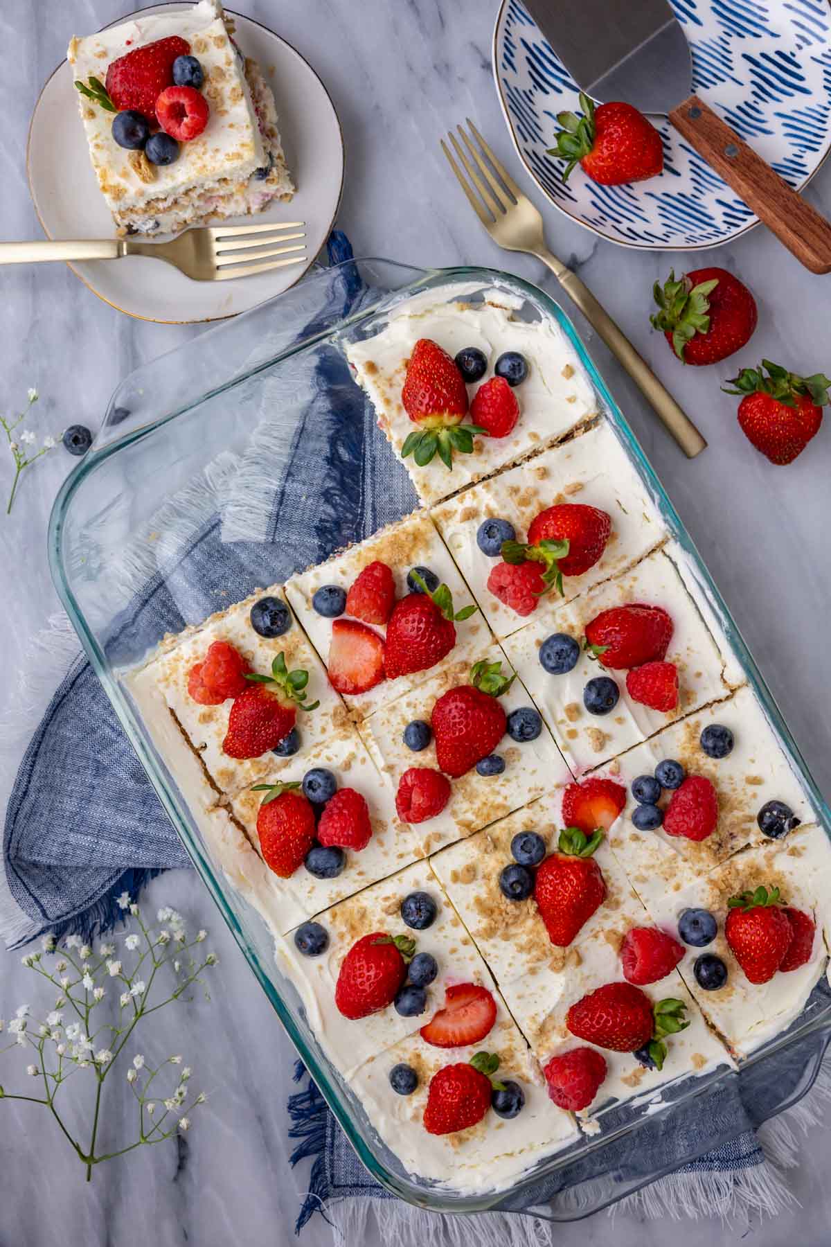 Overhead view of an icebox cake in a baking dish with two slices missing.