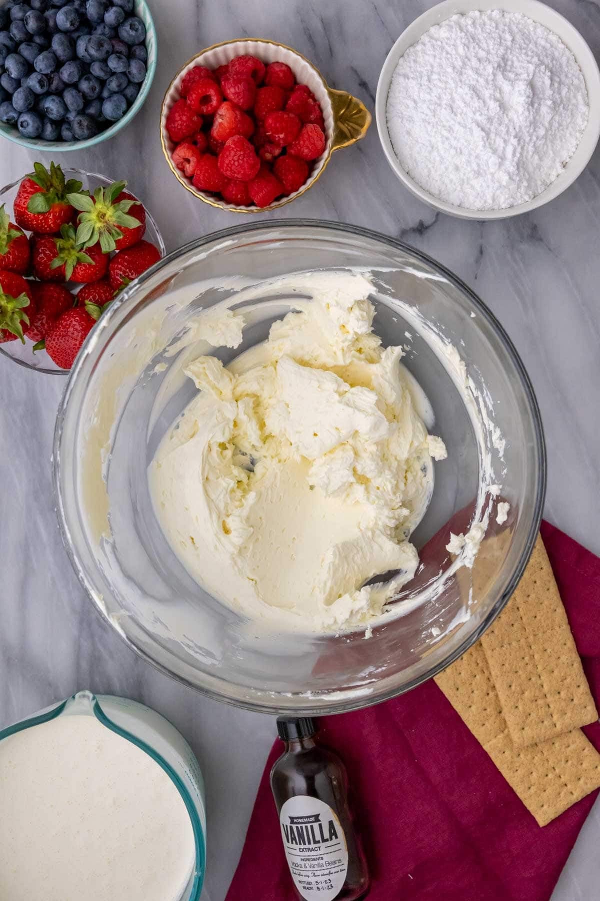 Overhead view of a bowl of cream cheese that's been beaten until creamy.