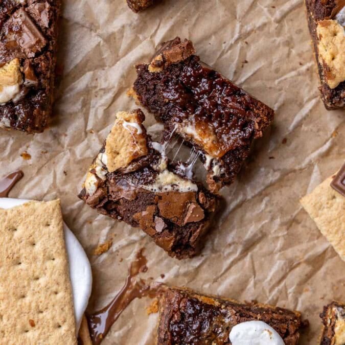 Overhead view of a s'mores brownie that's been broken in half to show a gooey center.