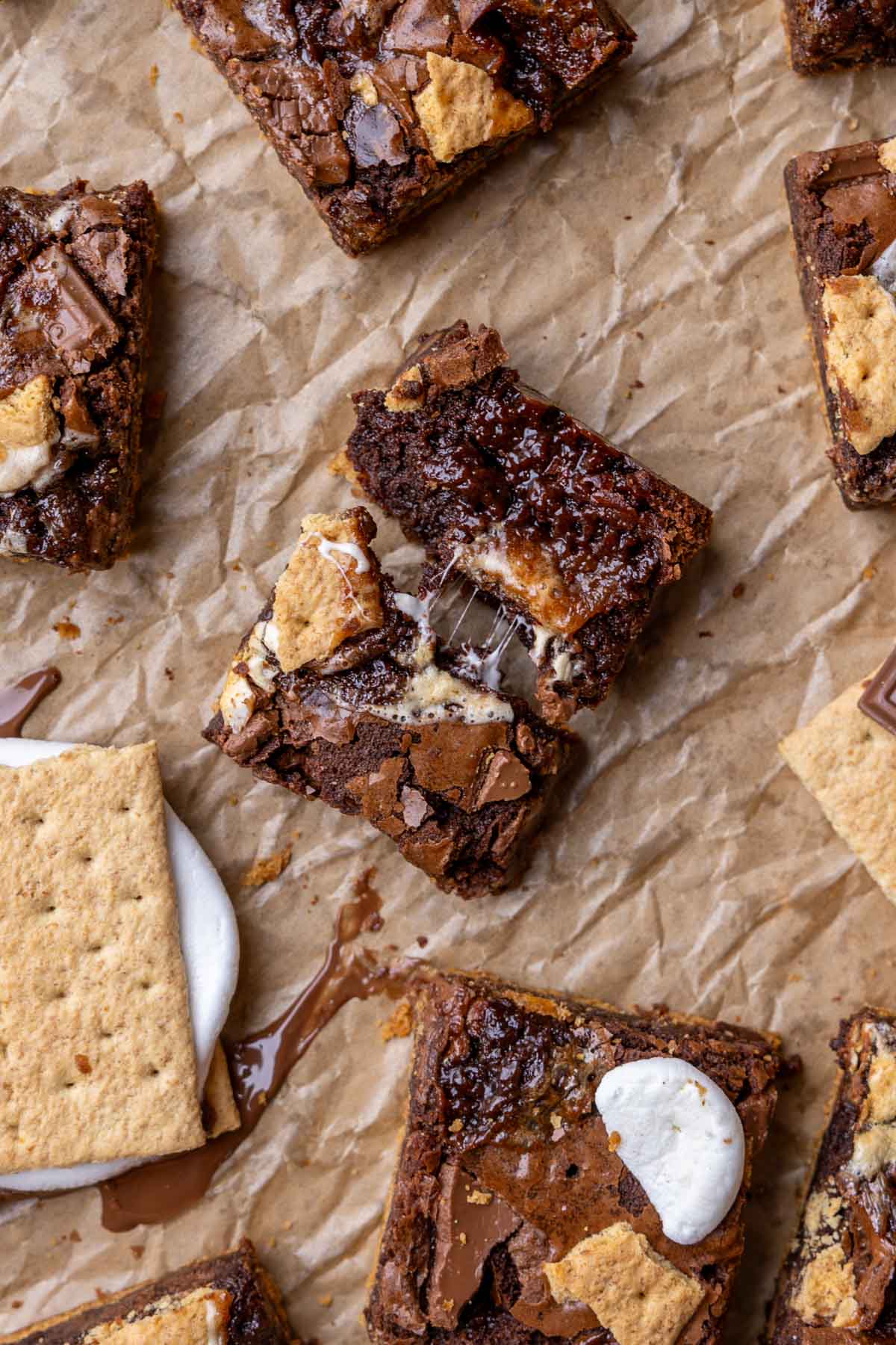Overhead view of a s'mores brownie that's been broken in half to show a gooey center.