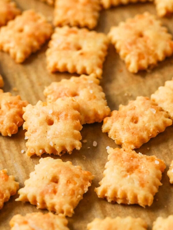 Close-up view of sourdough cheese crackers on a baking sheet.