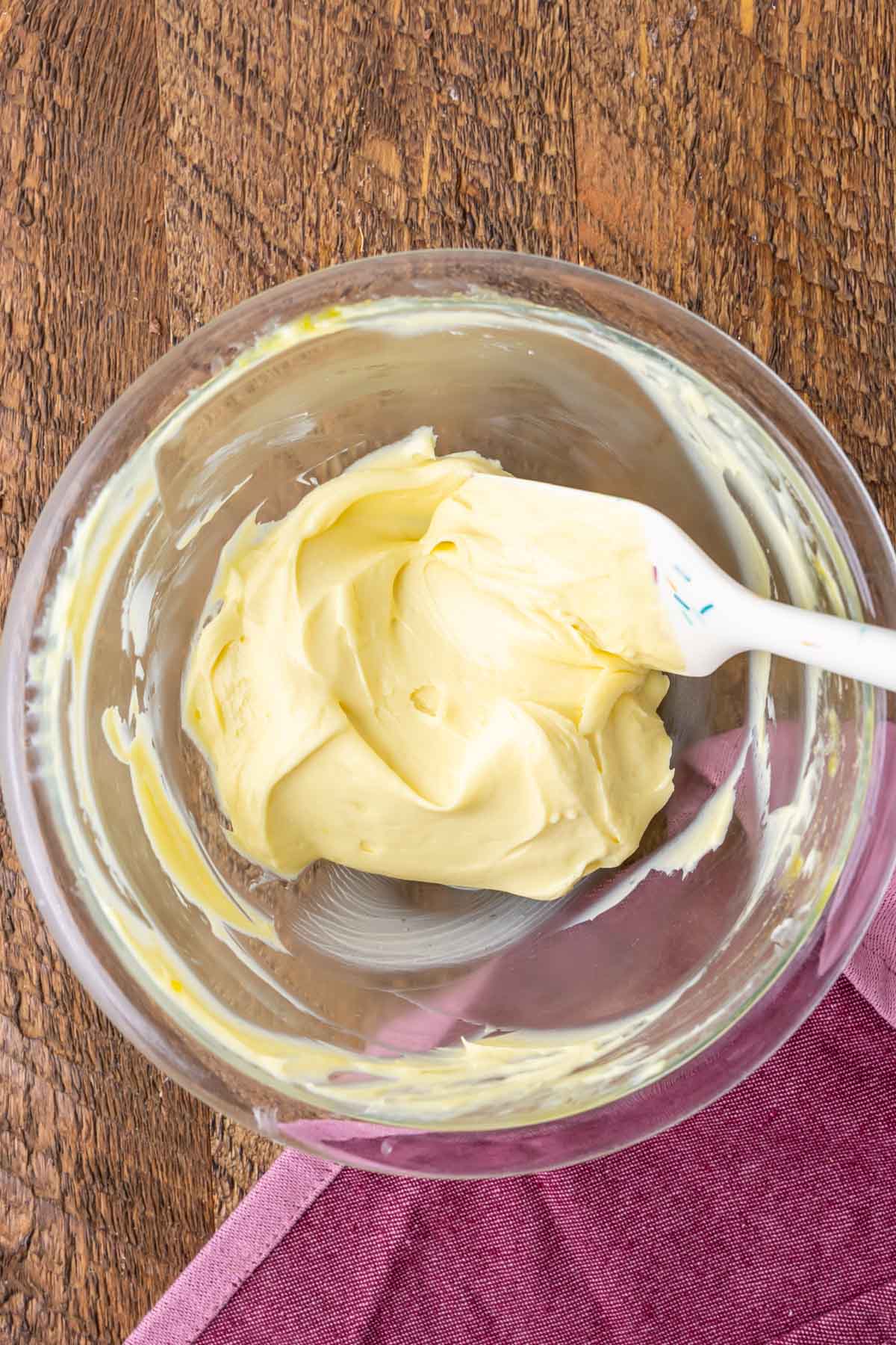 Overhead view of a cream cheese mixture being stirred together.