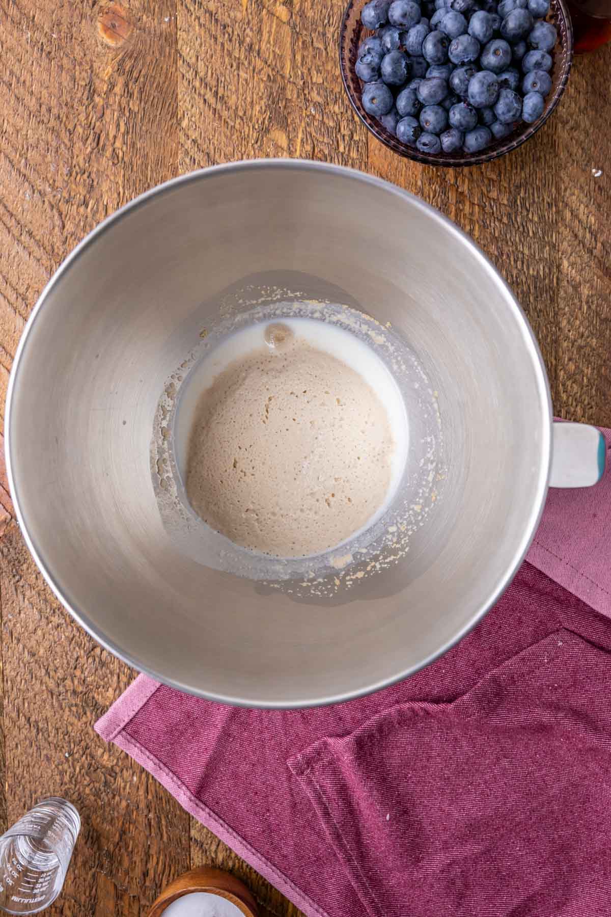 Overhead view of foamy yeast in a bowl.