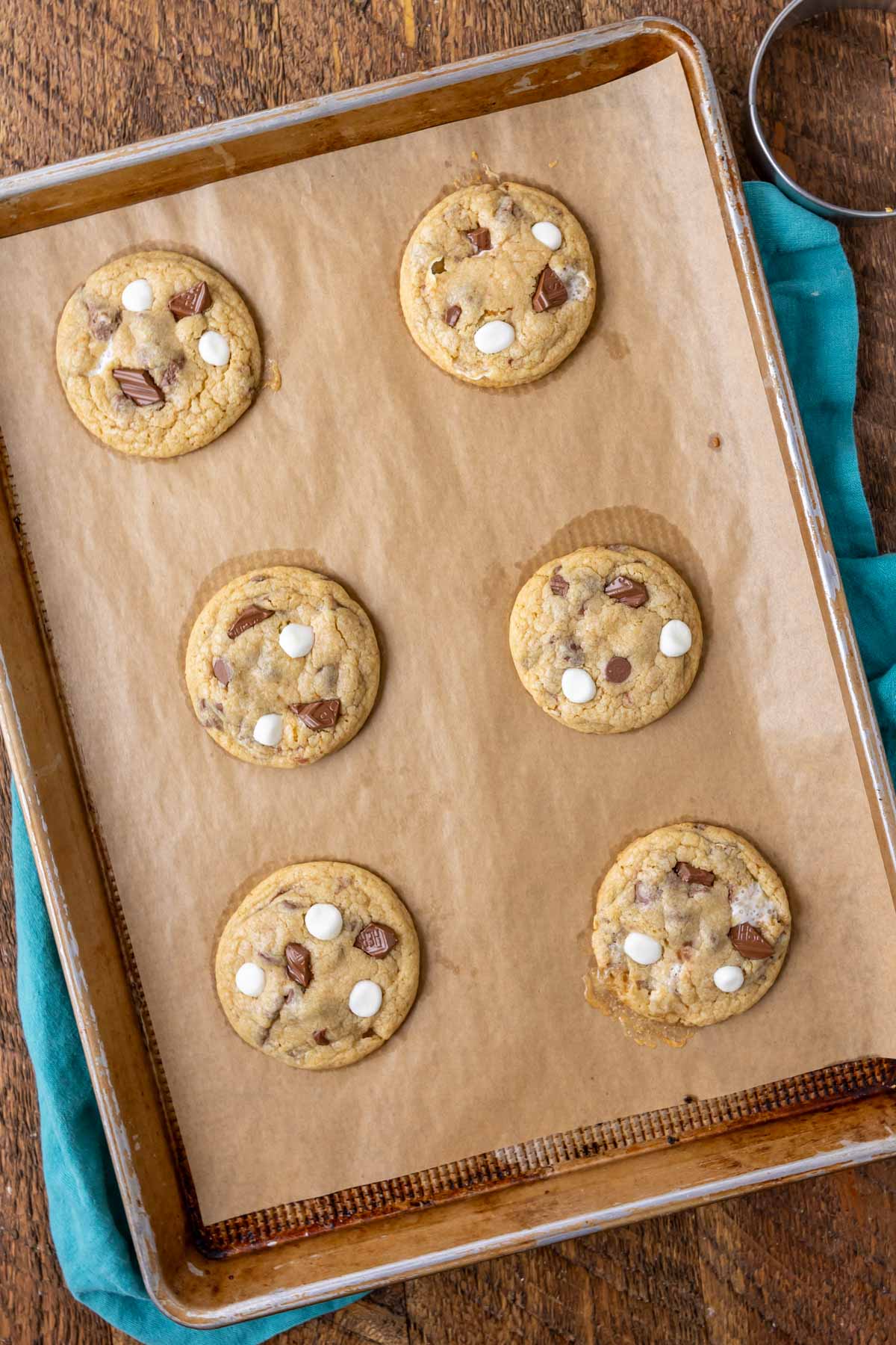 Overhead of 6 smores cookies on a baking sheet.