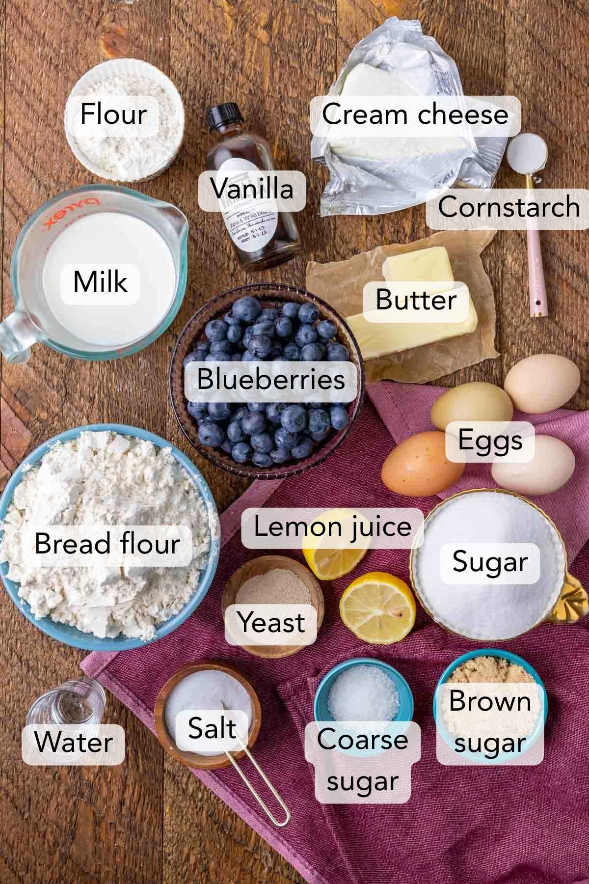 Overhead view of ingredients including blueberries, cream cheese, yeast, and more.
