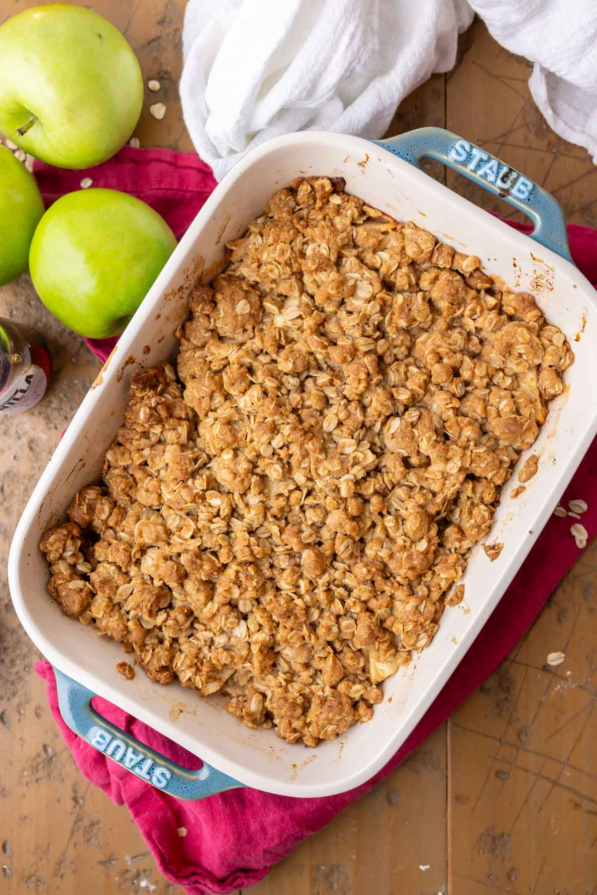 Overhead of apple crisp after baking on wood backdrop.