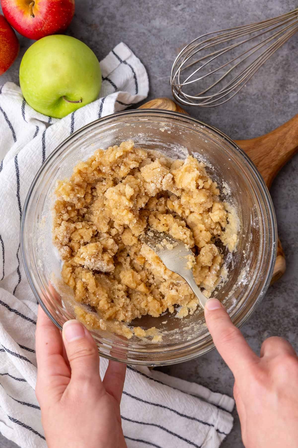 Overhead view of a crumble mixture being stirred together for an apple crumble recipe.