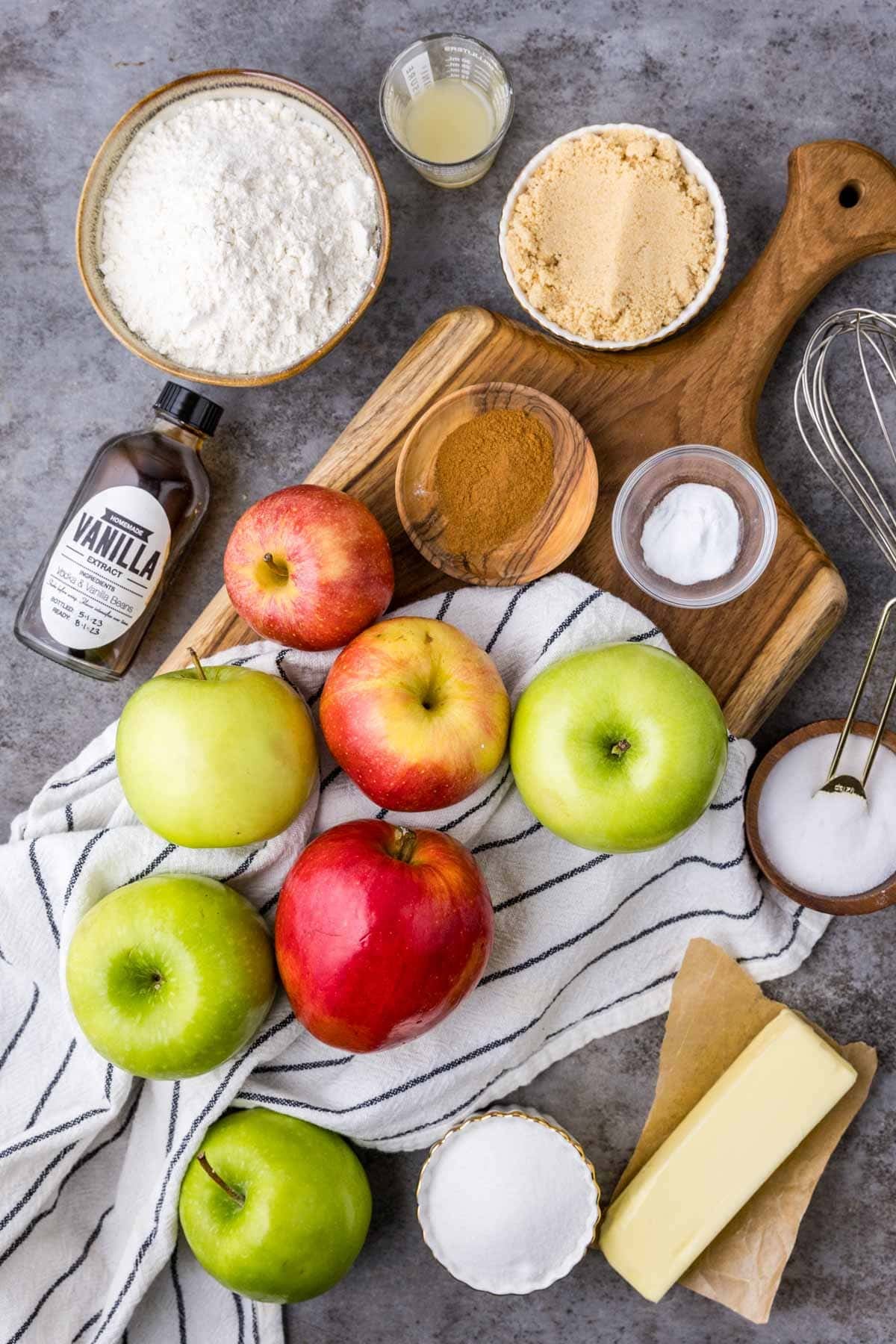 Overhead view of ingredients including apples, cinnamon, brown sugar, and more.