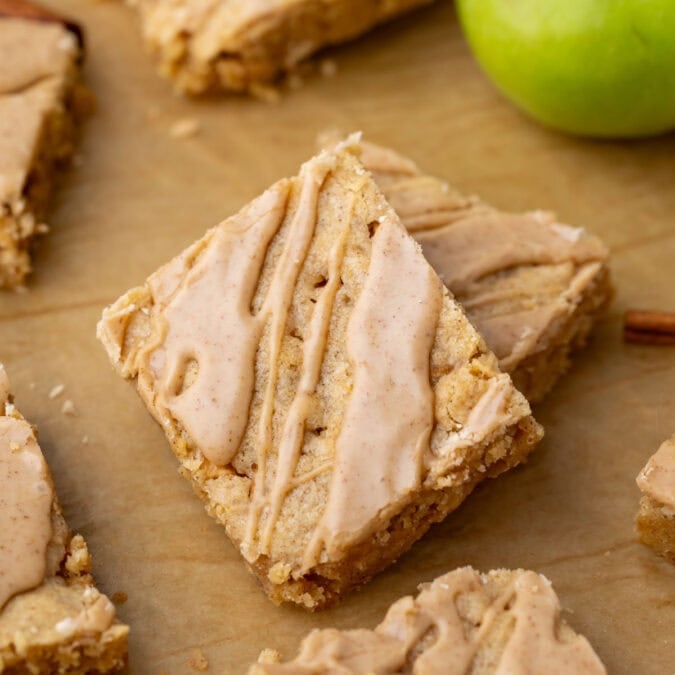 Close-up view of an apple blondies topped with a cinnamon maple glaze.