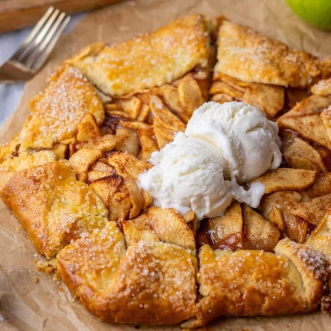 Golden brown and flaky apple galette topped with vanilla ice cream.