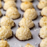 Close-up view of rows of coconut macaroons that have been dipped in chocolate.