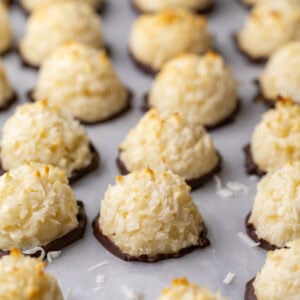 Close-up view of rows of coconut macaroons that have been dipped in chocolate.