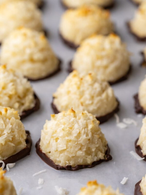 Close-up view of rows of coconut macaroons that have been dipped in chocolate.