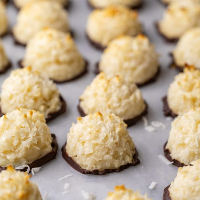 Close-up view of rows of coconut macaroons that have been dipped in chocolate.