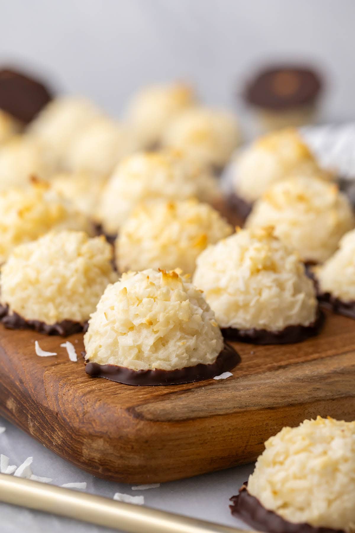 Close-up view of a chewy coconut cookie/candy hybrid that has been dipped in chocolate.