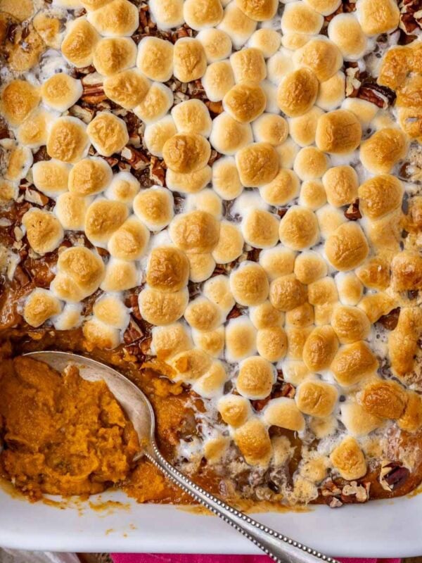 Overhead view of sweet potato casserole in a white dish with a spoon in the dish.