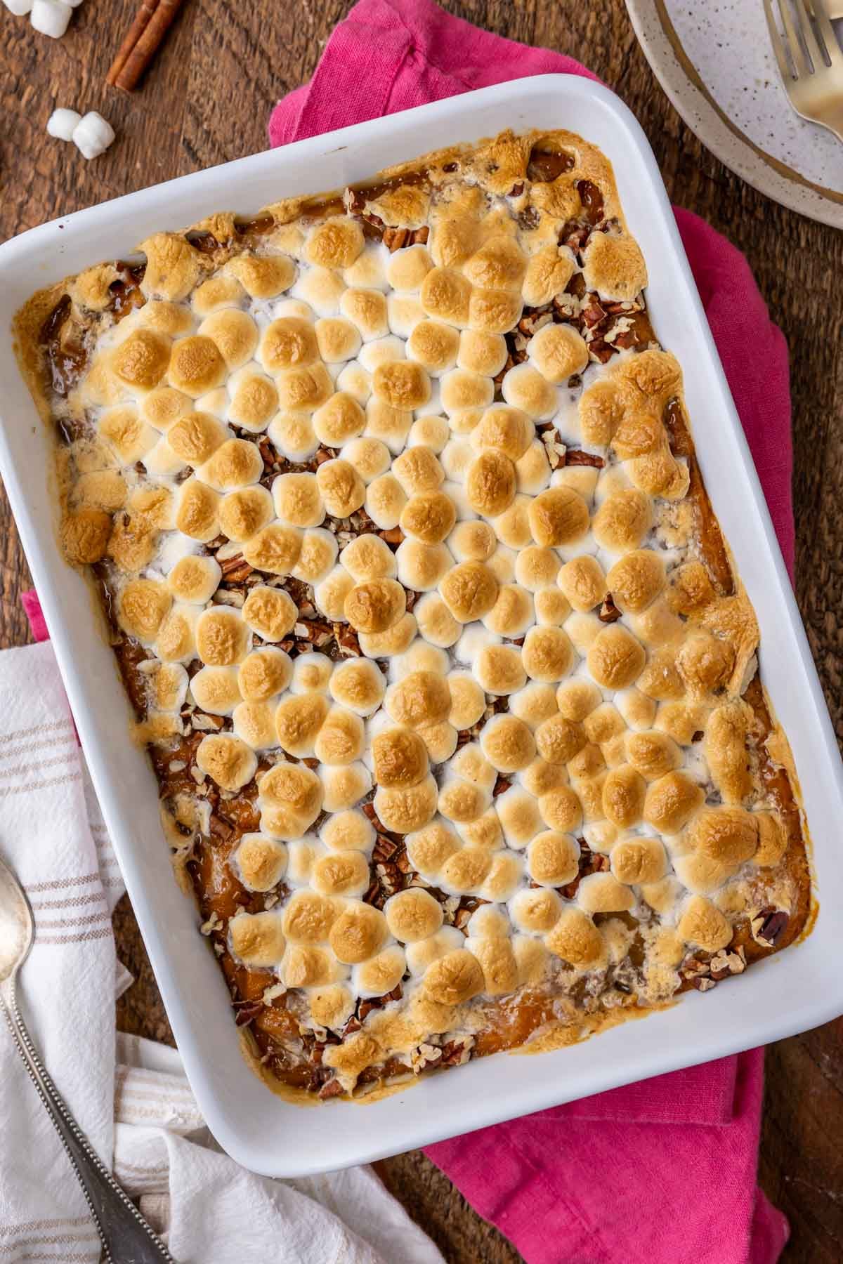 Overhead view of sweet potato casserole with golden brown mini marshmallows on top.