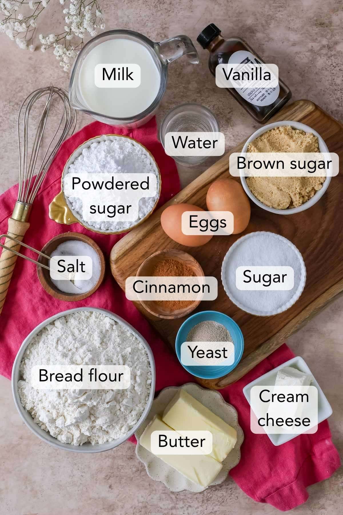 Labeled ingredients for homemade cinnamon rolls arranged on a countertop.