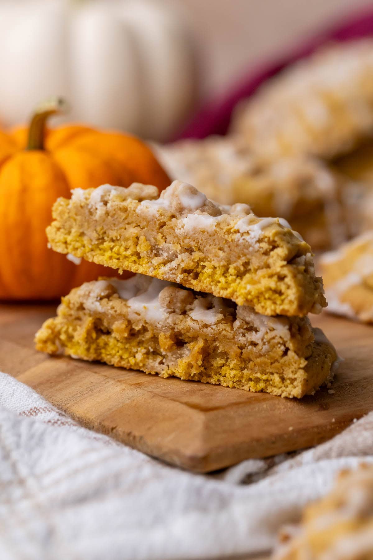 Two halves of a pumpkin coffee cake cookie stacked on top of each other.