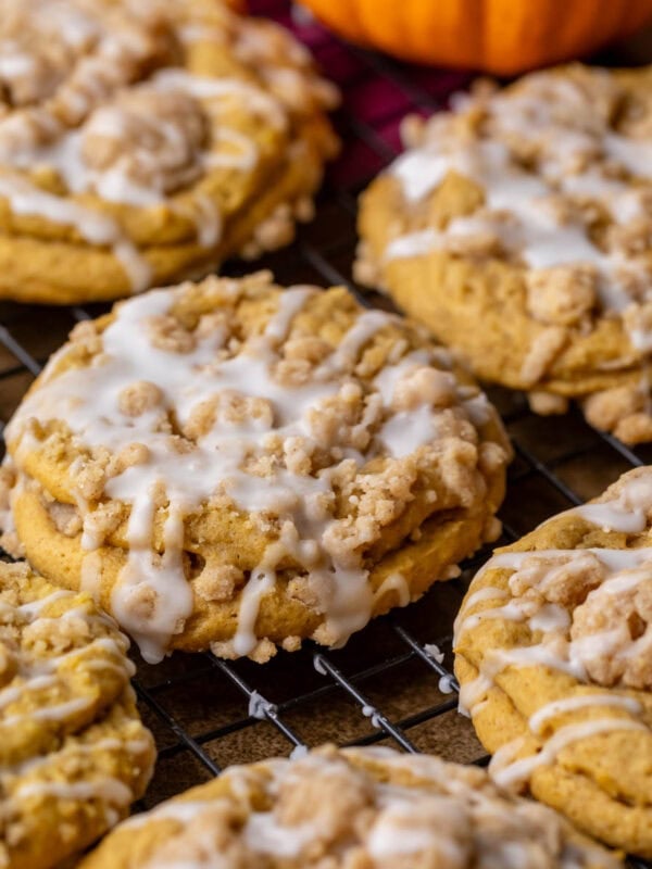 Overhead view of pumpkin coffee cake cookies topped with streusel and vanilla glaze.