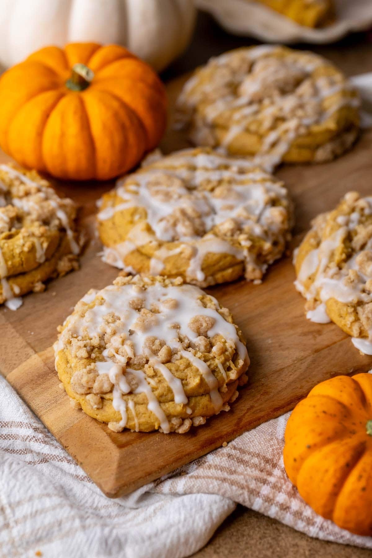Overhead view of pumpkin coffee cake cookies topped with streusel and glaze.