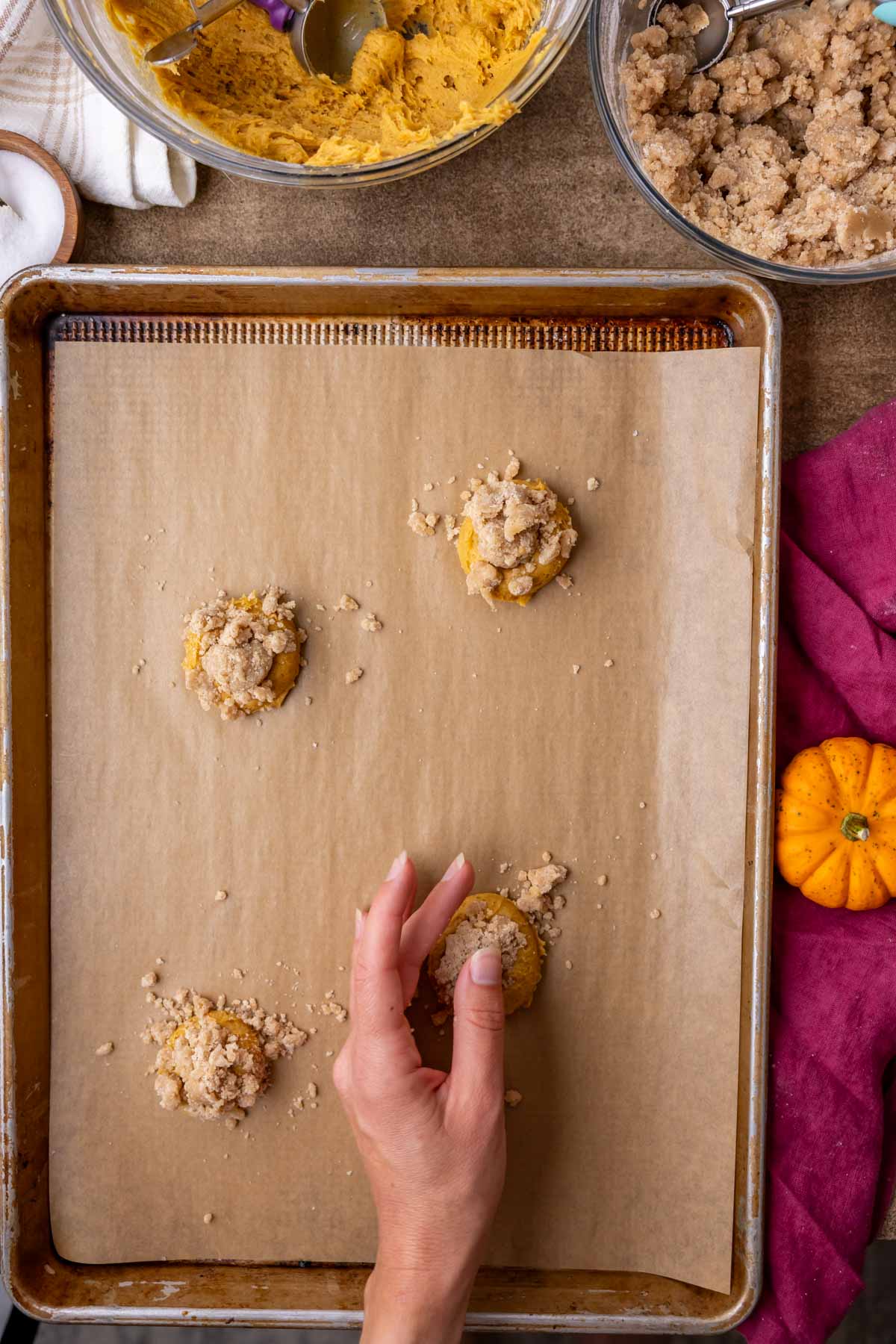 Layering streusel over pumpkin cookie dough.