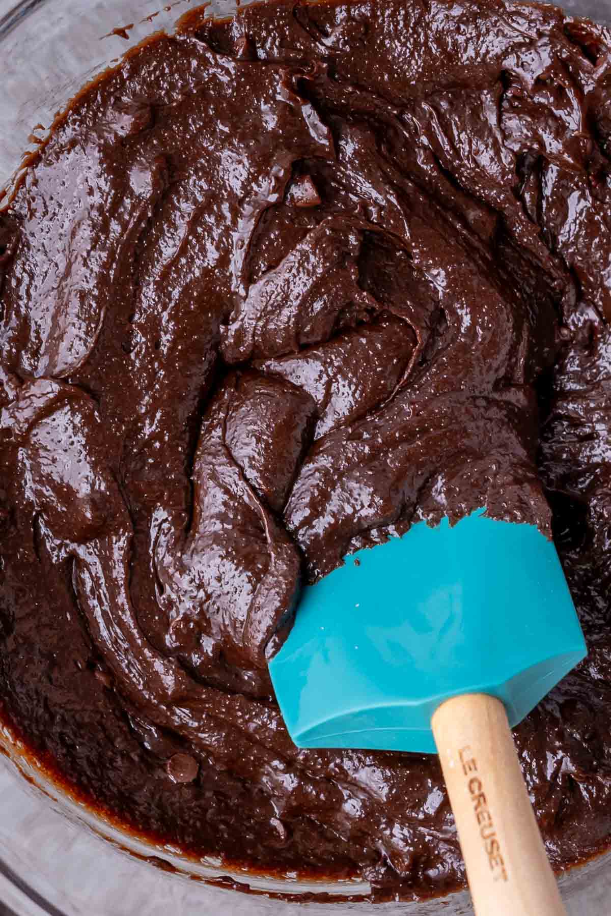 Close-up view of a glossy brownie batter.