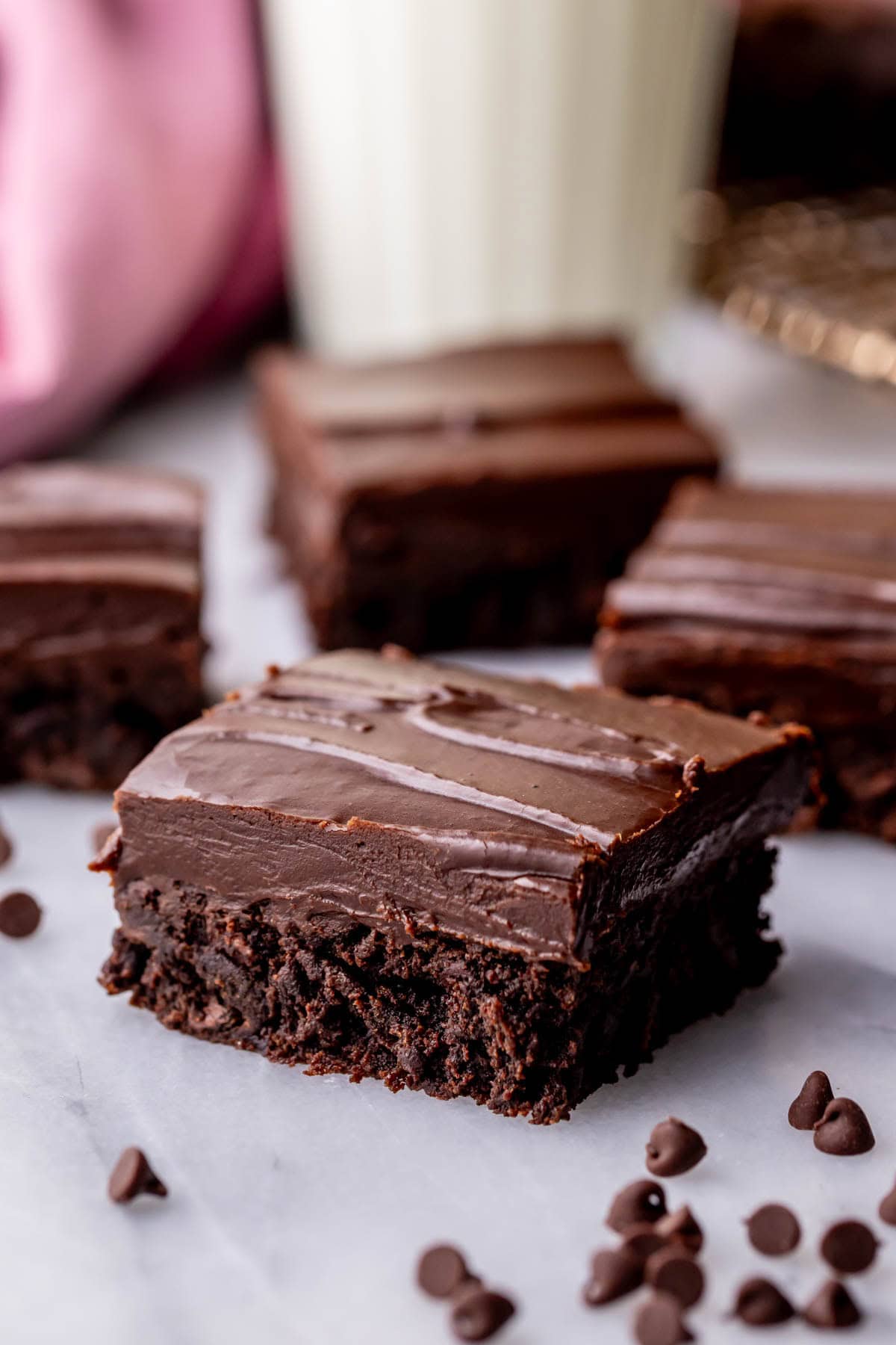 Close-up view of brownies topped with a thick fudge frosting.